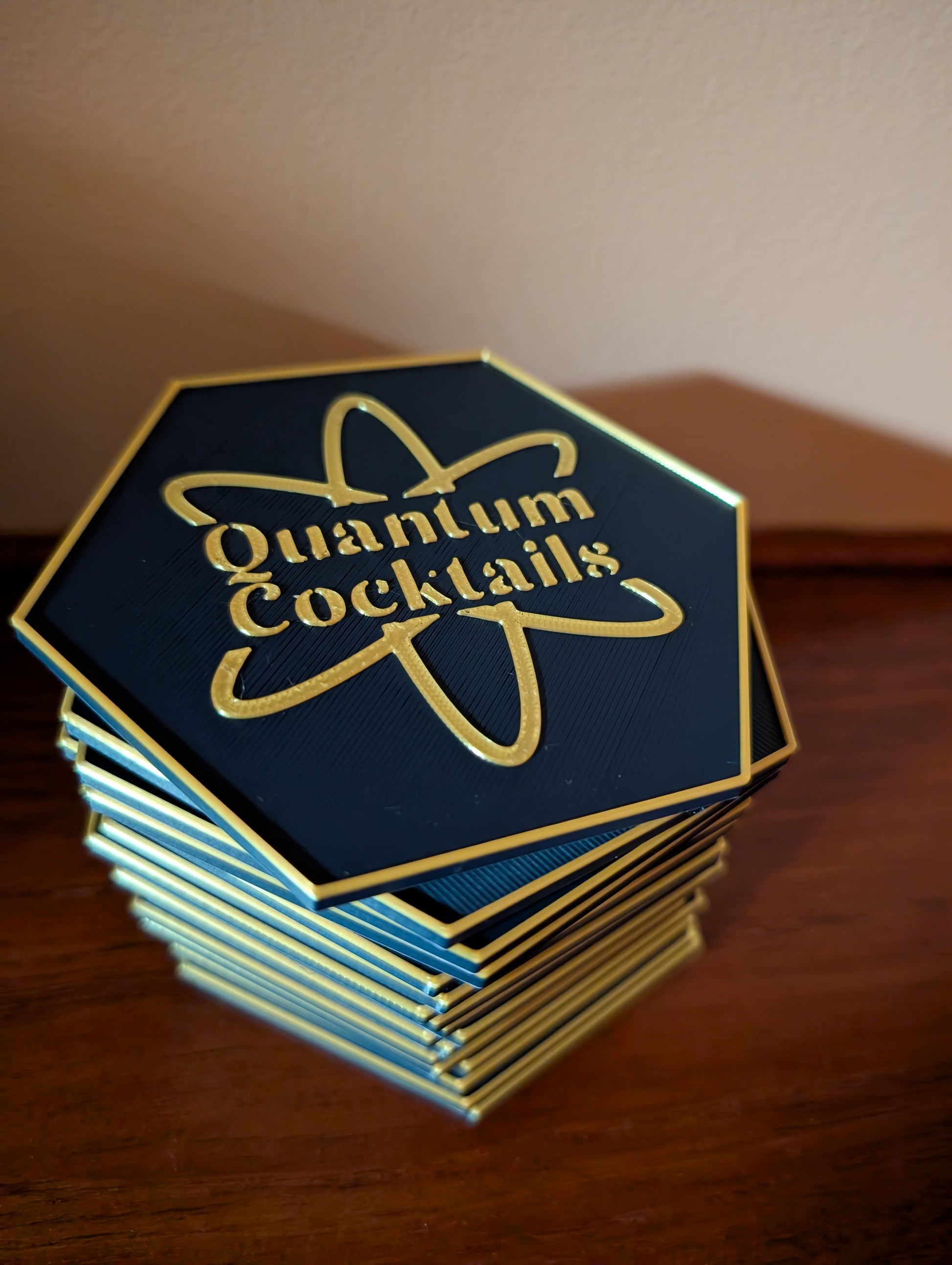 Stack of Quantum Cocktails coasters on a wooden surface