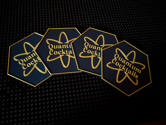 Quantum Cocktails coasters fanned out on a dark surface